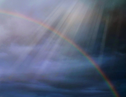 Rainbow with sunbeams